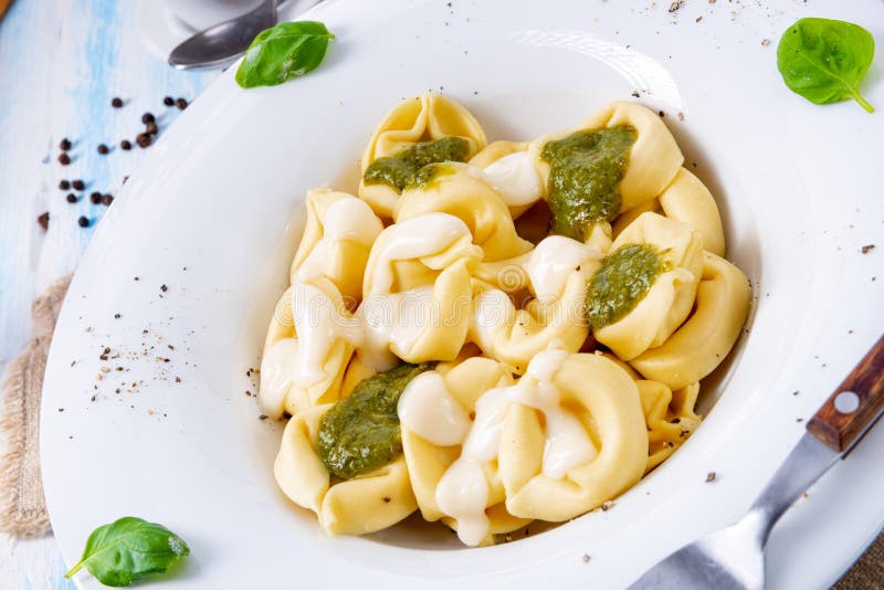 Tortellini Di Formaggio with Basil Pesto and Cheese Sauce Stock Image