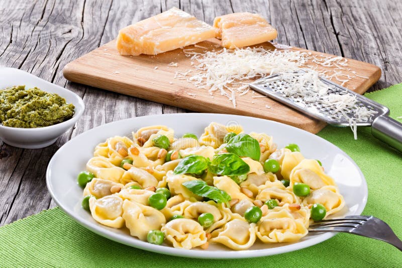 Tortellini with Green Peas, Pine Nuts, Parmesan Cheese and Grater Stock