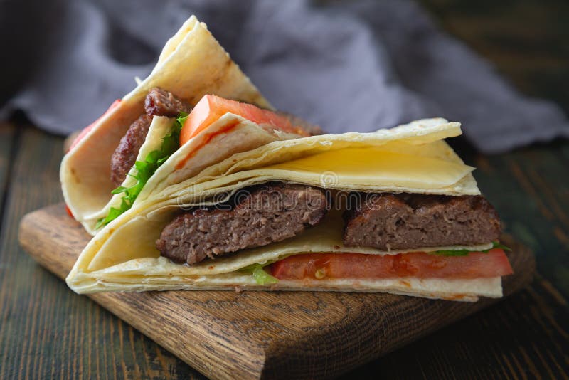 Tortilla Burger. Hamburger with Cheese and Vegetables Stock Image