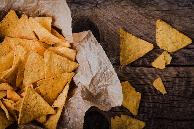 Tortilla chips in craft  bowl on rustic wooden table