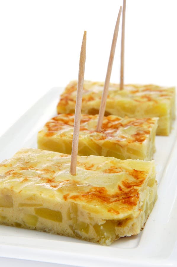 Closeup of a typical spanish pinchos de tortilla, pieces of potato omelet served as tapas with toothpicks. Closeup of a typical spanish pinchos de tortilla, pieces of potato omelet served as tapas with toothpicks
