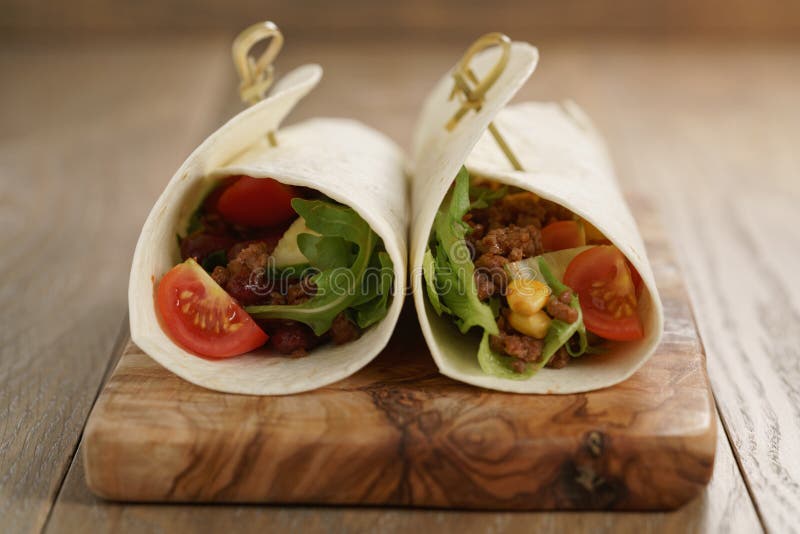 Tortilla Wrap Sandwiches with Beef and Vegetables on Olive Board Stock ...