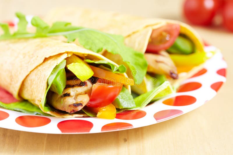 Tortilla with grilled chicken and vegetables on the plate. Tortilla with grilled chicken and vegetables on the plate