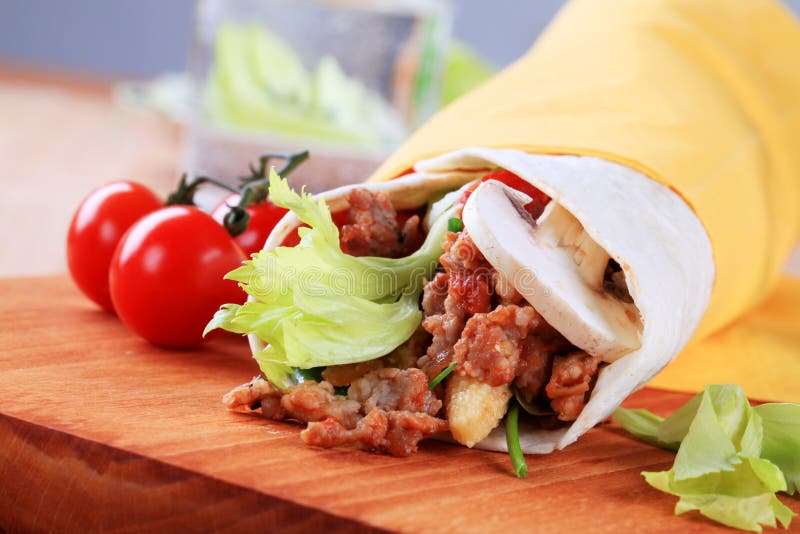 Tortilla wrap with meat and salsa - detail. Tortilla wrap with meat and salsa - detail