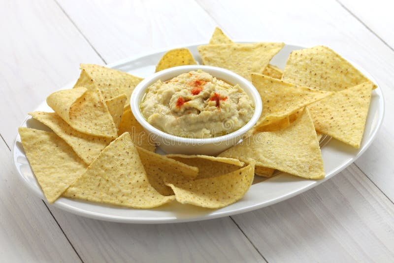 Tortilla chips with hummus dip for super bowl. Tortilla chips with hummus dip for super bowl