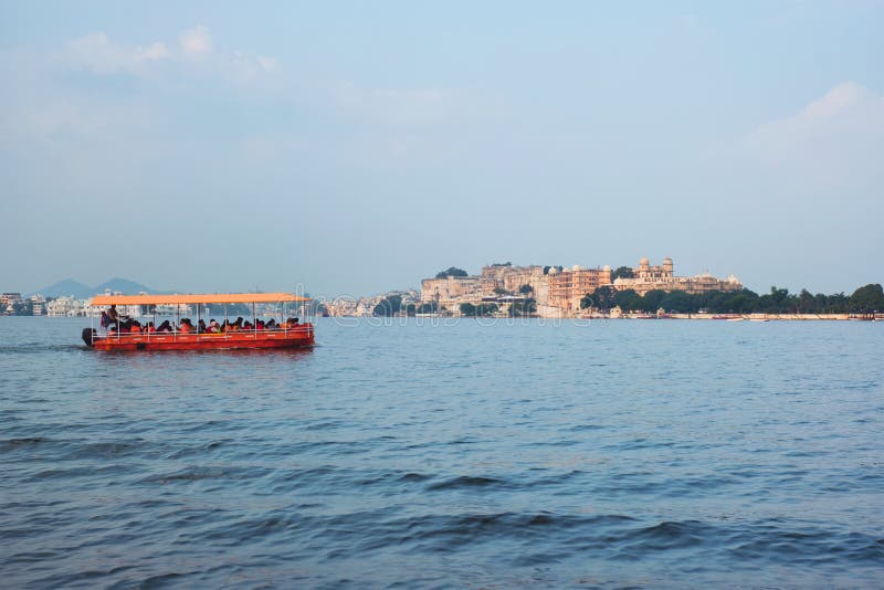 Toruist boat in Lake Pichola with City Palace in background. Udaipur, Rajasthan, India. Toruist boat in Lake Pichola with City Palace in background. Udaipur, Rajasthan, India