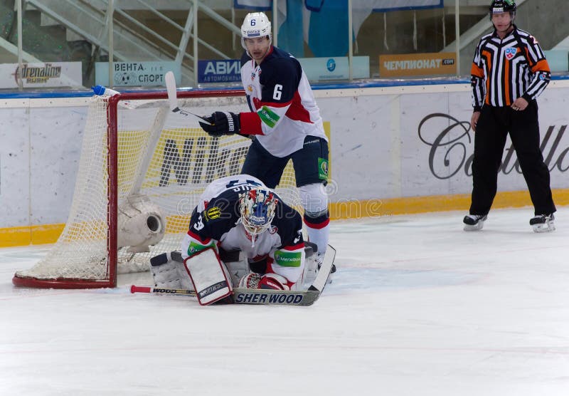 MOSCOW - JANUARY 28, 2014: Janus Jaroslav (32) goaltender of Slovan team catch a puck during the KHL hockey match Dynamo Moscow vs Slovan Bratislava in sport palace Luzhniki in Moscow, Russia. Final score 2:3. MOSCOW - JANUARY 28, 2014: Janus Jaroslav (32) goaltender of Slovan team catch a puck during the KHL hockey match Dynamo Moscow vs Slovan Bratislava in sport palace Luzhniki in Moscow, Russia. Final score 2:3