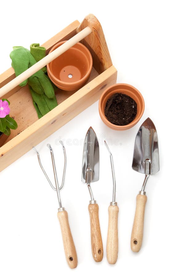 A gardener's tote box on a white background with tools, plants and gloves. A gardener's tote box on a white background with tools, plants and gloves