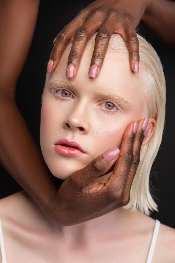 African-American woman touching face of woman with white skin stock images African-American woman touching face of woman with white skin stock images
