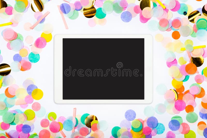 Touchpad with blank screen on colorful confetti background. Color party background with touchscreen pc royalty free stock image Touchpad with blank screen on colorful confetti background. Color party background with touchscreen pc royalty free stock image