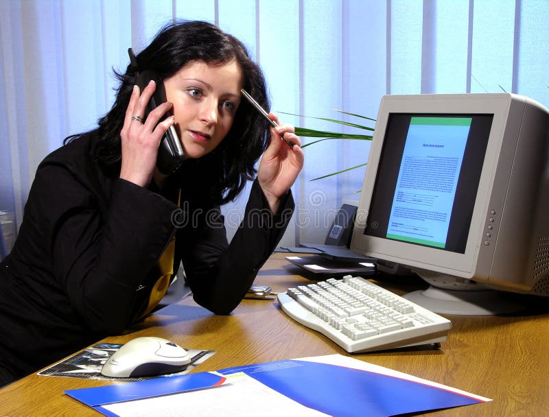 Tough question. Business woman discussing over the phone with a business partner and looking thoughtful Tough question. Business woman discussing over the phone with a business partner and looking thoughtful