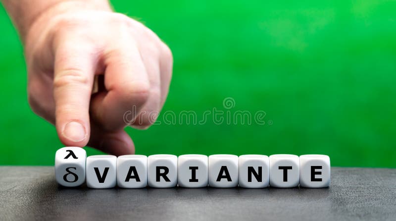 Tour à la main dice et change l'expression allemande delta delta variante en lambda lambda variante. images stock