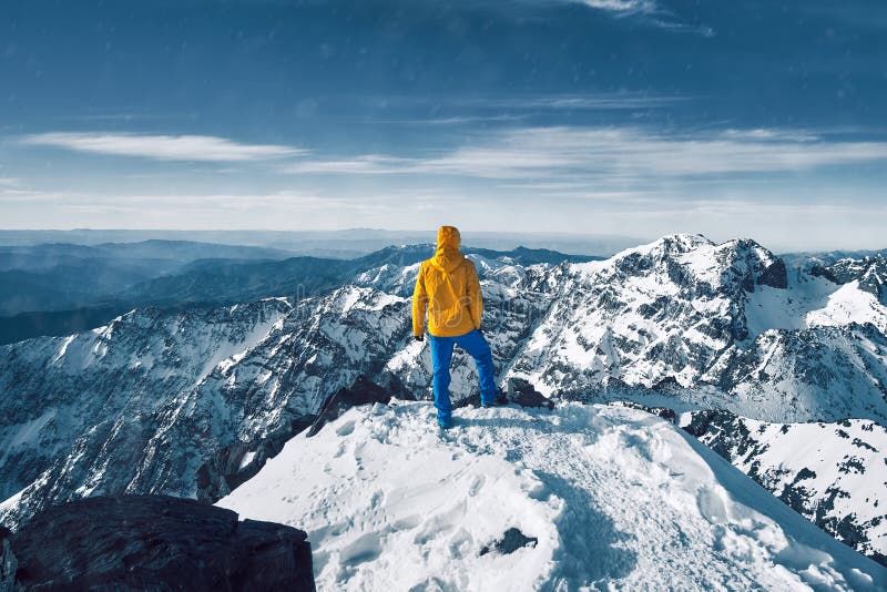Tourist alone standing and meditating over snow covered Atlas mountain range royalty free stock photos Tourist alone standing and meditating over snow covered Atlas mountain range royalty free stock photos
