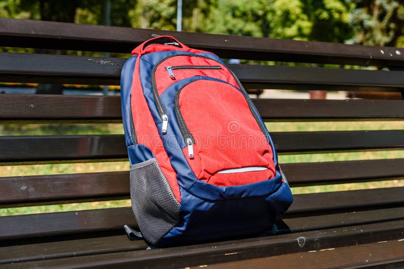 Tourist Backpack on a Bench in City Park Stock Image - Image of bench ...