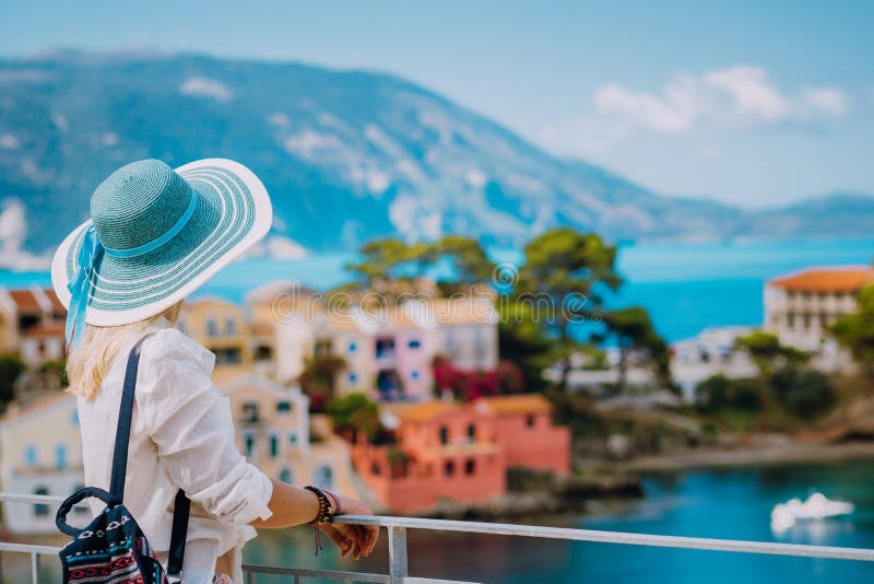 Tourist blond women with sun hat in cute colorful small Assos village. Kefalonia, Greece stock images Tourist blond women with sun hat in cute colorful small Assos village. Kefalonia, Greece stock images