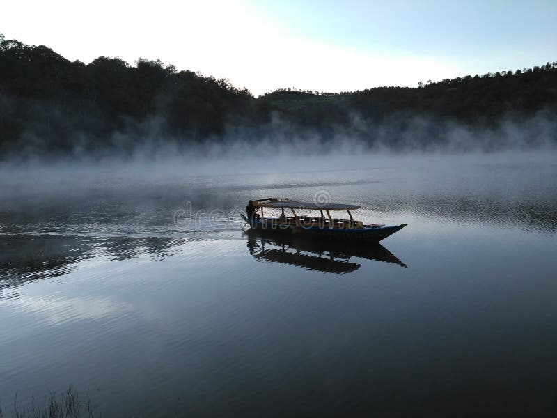 Boat on misty lake stock image. Image of foggy, water - 36944601