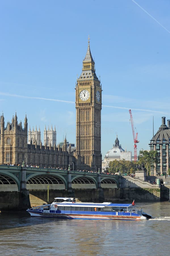 Tourist Boat sailing under Westminster Bridge.