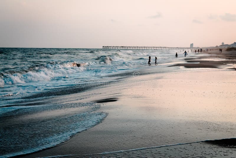 Tourist Enjoying the Atlantic Ocean at Ocean Isle Beach North Carolina Stock Image - Image of