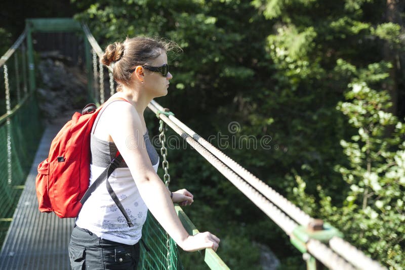 Tourist girl on hanging bridge