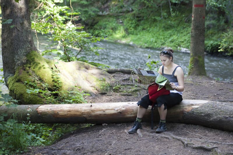 Tourist girl reading a map