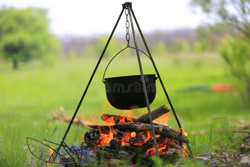 Cauldron or Camping Kettle Over Open Fire Outdoors Stock Image