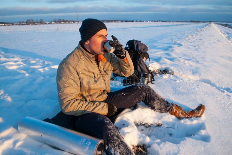 Tourist over a Cup of hot tea watching the sunset, coffee on a winter day, adventure Concept outdoor activities. Winter royalty free stock photo Tourist over a Cup of hot tea watching the sunset, coffee on a winter day, adventure Concept outdoor activities. Winter royalty free stock photo