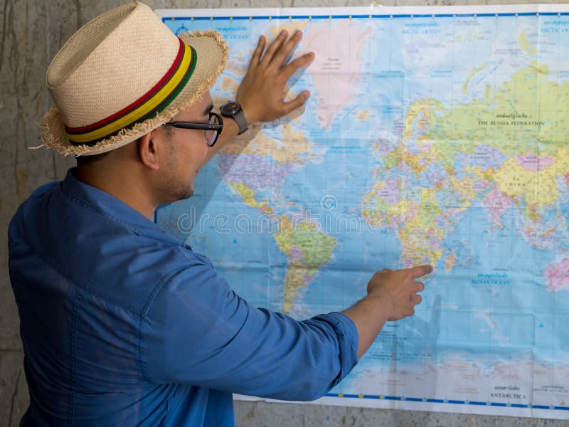 Tourist pointing at worldmap for next destination. stock photography