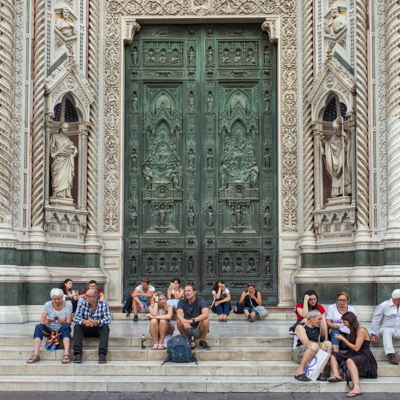 Tourist Resting on the Stairs in Front of West Door of the Duomo ...