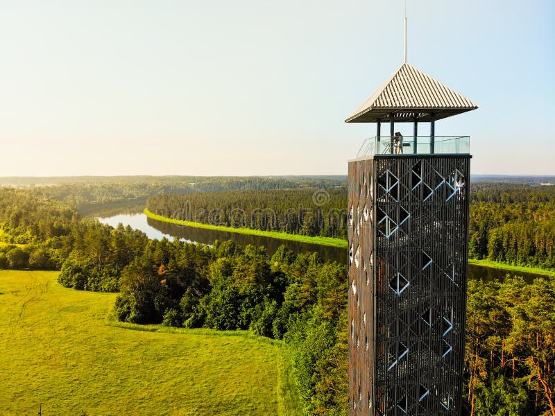Tourist stand on top look out Birstonas observation tower - highest such tower in Lithuania. Drone aerial outdoors