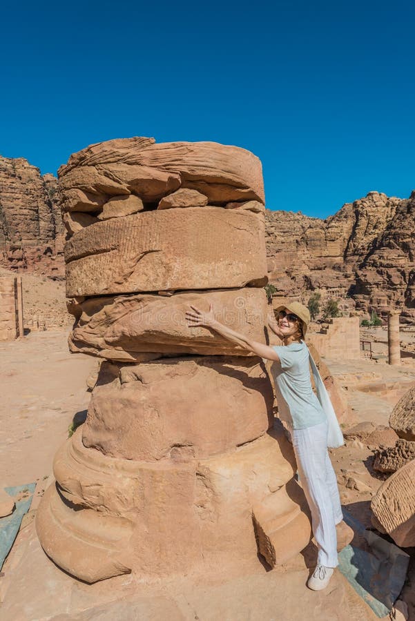 Tourist standing roman temple in nabatean city of petra jordan