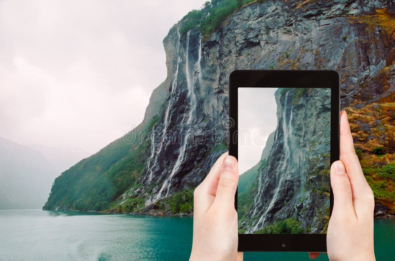 Tourist taking photo of seven sisters waterfall