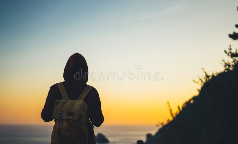 Tourist traveler with backpack on morning relax time, hiker looking on sunset to valley in trip, hipster young girl enjoying peak royalty free stock photo Tourist traveler with backpack on morning relax time, hiker looking on sunset to valley in trip, hipster young girl enjoying peak royalty free stock photo