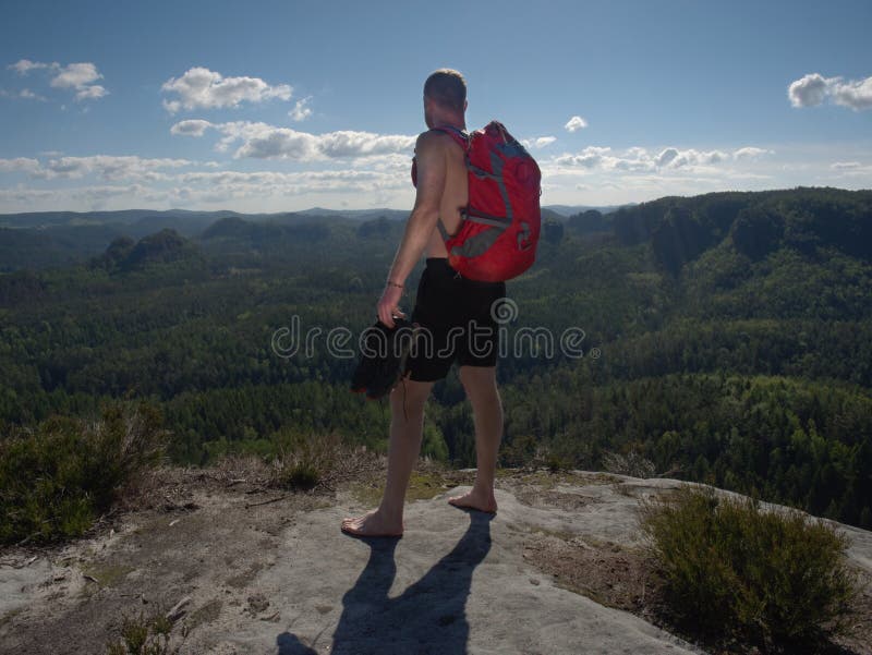 Tourist watch land from mountain top. Man wear backpack stock photos Tourist watch land from mountain top. Man wear backpack stock photos