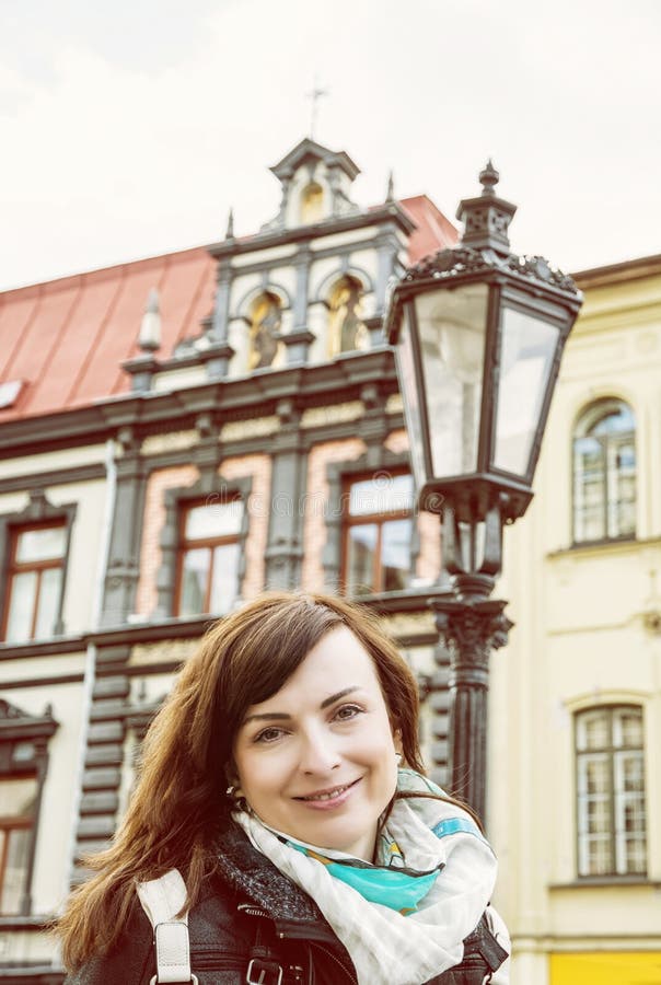 Tourist woman with building and old lantern in Main square, Kosice