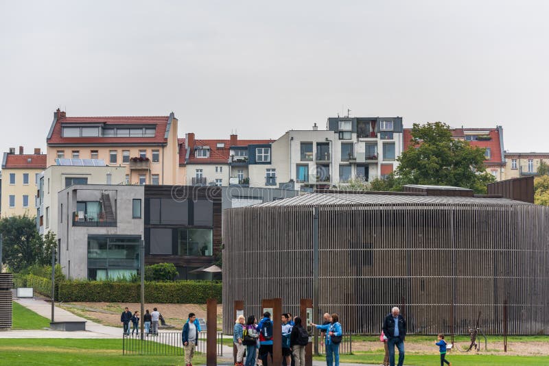 Tourists people at the Berlin Wall Memorial  with background of Chapel Of Reconciliation in Berlin, Germany. Tourists people at the Berlin Wall Memorial  with background of Chapel Of Reconciliation in Berlin, Germany.