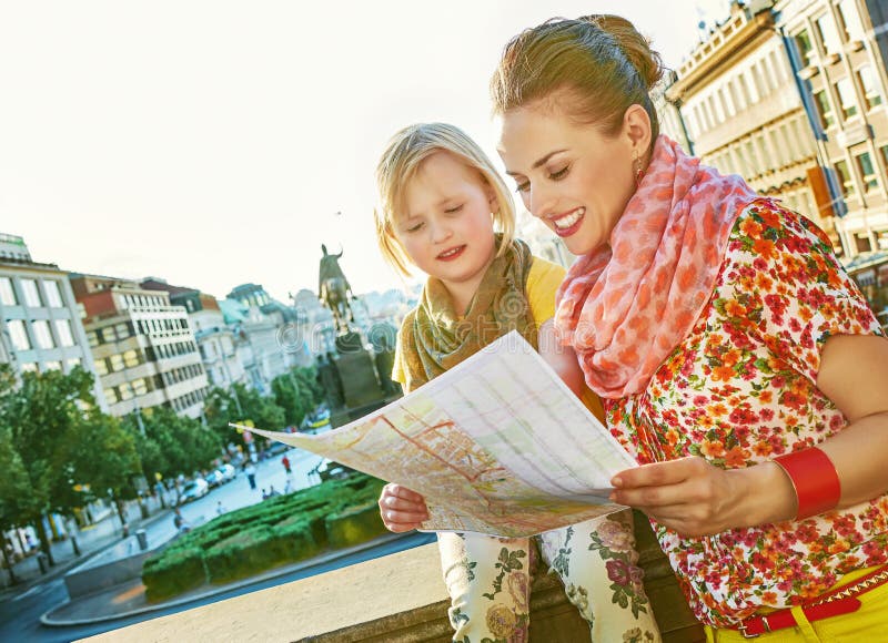 The spirit of old Europe in Prague. smiling young mother and daughter tourists on Vaclavske namesti in Prague, Czech Republic looking at the map. The spirit of old Europe in Prague. smiling young mother and daughter tourists on Vaclavske namesti in Prague, Czech Republic looking at the map