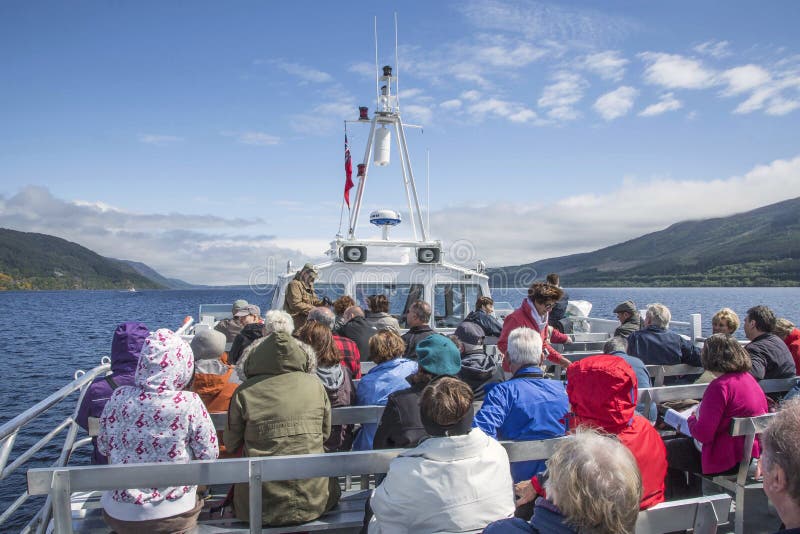 Tourists on Loch Ness cruise boat in Highlands of Scotland. Tourists on Loch Ness cruise boat in Highlands of Scotland.