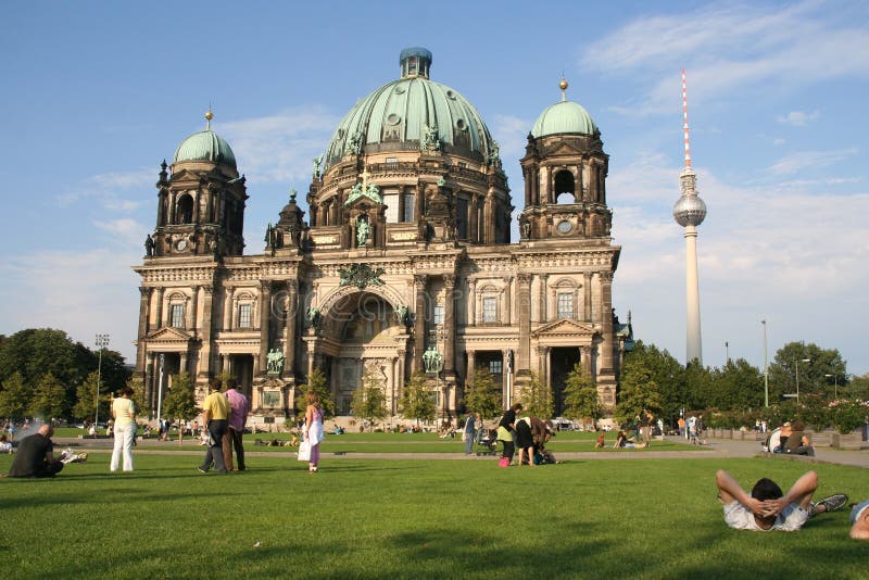 Tourists on the lawn in front of the Berlin Cathedral, with the TV tower behind it. Tourists on the lawn in front of the Berlin Cathedral, with the TV tower behind it