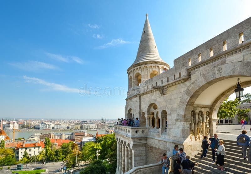 Tourists visit the Matthias Church square with the Fisherman`s Bastion behind at the Buda Castle Complex in Budapest, Hungary. Tourists enjoy the city and Danube royalty free stock photos Tourists visit the Matthias Church square with the Fisherman`s Bastion behind at the Buda Castle Complex in Budapest, Hungary. Tourists enjoy the city and Danube royalty free stock photos
