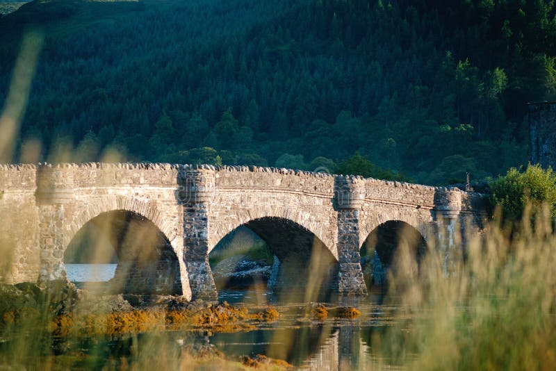 Tourists favourite place in Scotland - Isle of Skye. Very famous castle in Scotland called Eilean Donan castle. Scotland green nature. Top of the mountains. Beautiful nature. Scottish Highlands. Castle with reflection in the lake