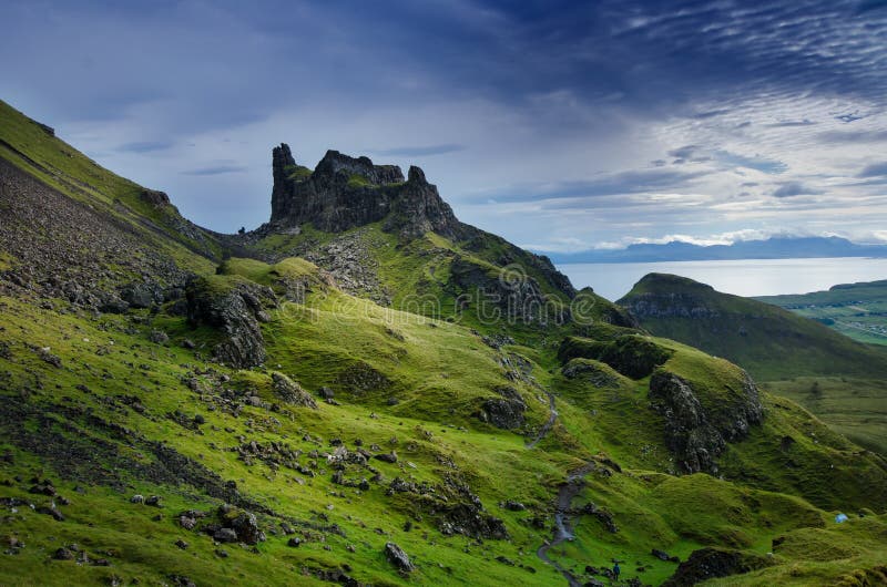 Tourists favourite place in Scotland - Isle of Skye. Very famous castle in Scotland called Eilean Donan castle. Scotland green nature. Top of the mountains. Beautiful nature. Scottish Highlands. Castle with reflection in the lake