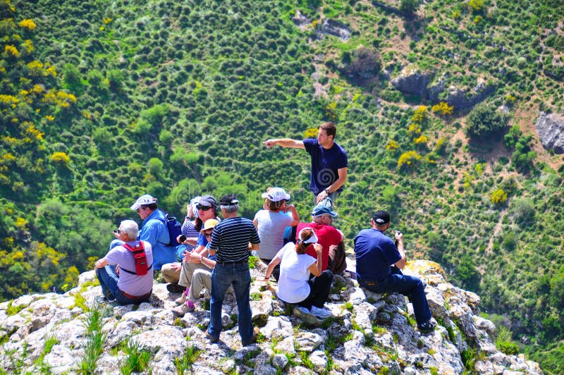 Tourists and guide on cliff edge, Israel