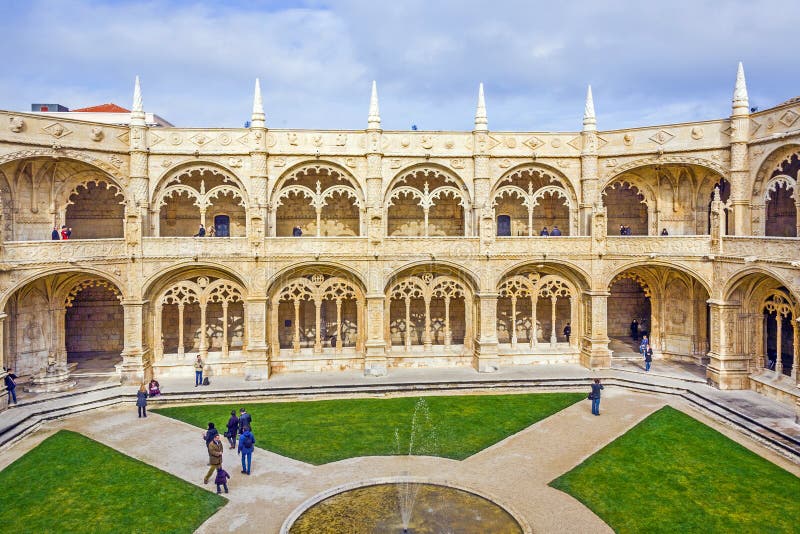 Tourists in the inner courtyard of the Jeronimos Monastery Cloister in Lisbon