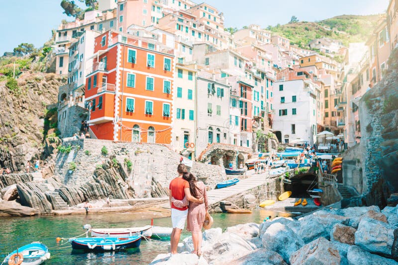 Tourists looking at scenic view of Riomaggiore, Cinque Terre, Liguria, Italy