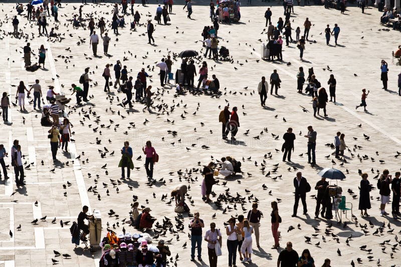 Tourists on San Marco square feed