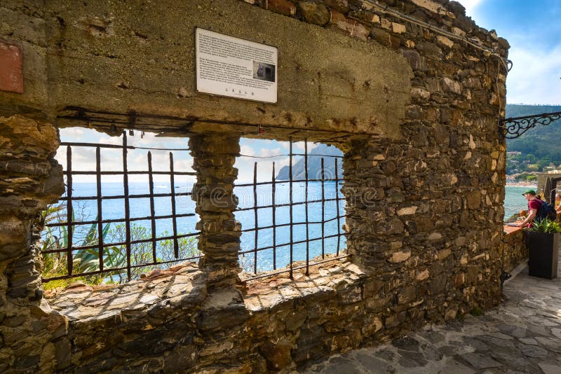 An ancient wall overlooking the Ligurian Sea at Monterosso al Mare, Italy, Cinque Terre. Tourists stop to enjoy the view of the Ligurian Sea on the walking path royalty free stock images An ancient wall overlooking the Ligurian Sea at Monterosso al Mare, Italy, Cinque Terre. Tourists stop to enjoy the view of the Ligurian Sea on the walking path royalty free stock images
