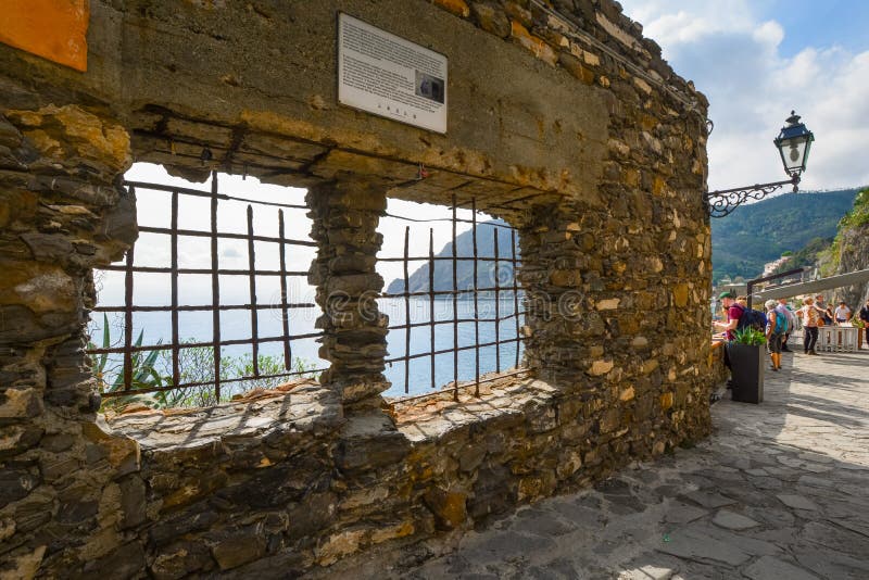 An ancient stone wall overlooking the Ligurian Sea at Monterosso al Mare, Italy, Cinque Terre. Tourists stop to enjoy the view of the Ligurian Sea on the walking royalty free stock photos An ancient stone wall overlooking the Ligurian Sea at Monterosso al Mare, Italy, Cinque Terre. Tourists stop to enjoy the view of the Ligurian Sea on the walking royalty free stock photos