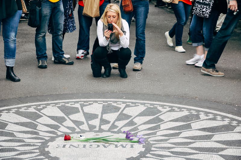 Tourists at the Strawberry Field in Manhattan. stock photo Tourists at the Strawberry Field in Manhattan. stock photo