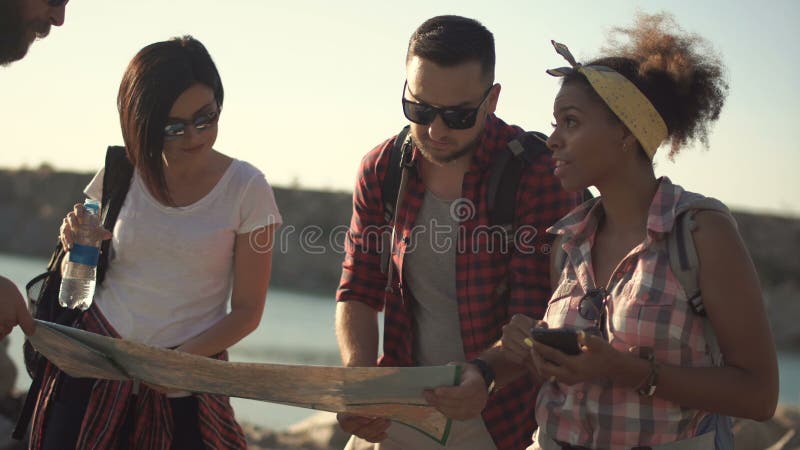 Tourists travelers watching map stock footage