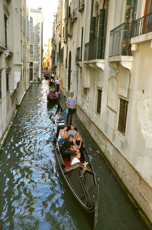 Tourists in boats called gondolas in Venice , Italy.Italian tourism concept . Tourists in boats called gondolas in Venice , Italy.Italian tourism concept .